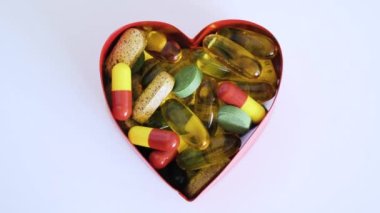 Medical pills are in the shape of a heart for baking. The topic of health care, treatment and prevention of diseases.