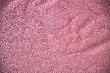 Crumpled pink terry cloth. Fabric texture. Up close