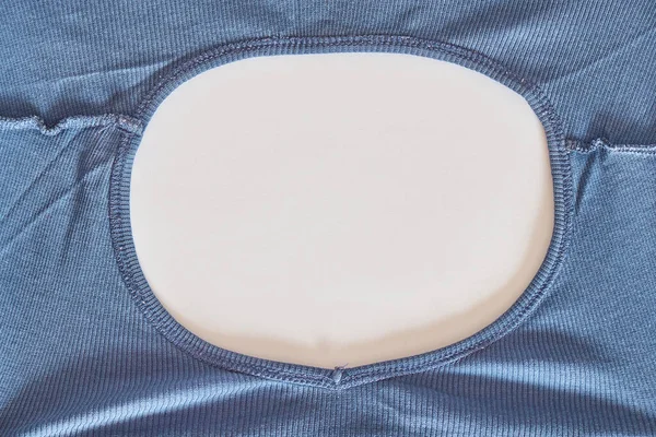 The collar of a blue T-shirt. View from above.