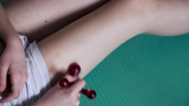 Das Mädchen Benutzt Einen Massagegerät Eine Akupunkturpunktmassage Des Oberschenkels Durchzuführen — Stockvideo