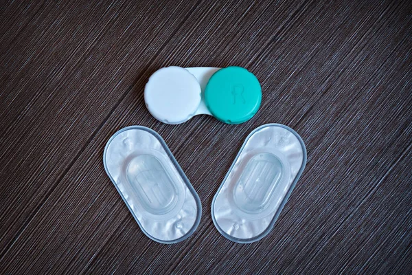Close-up of packed contact lenses and their container.