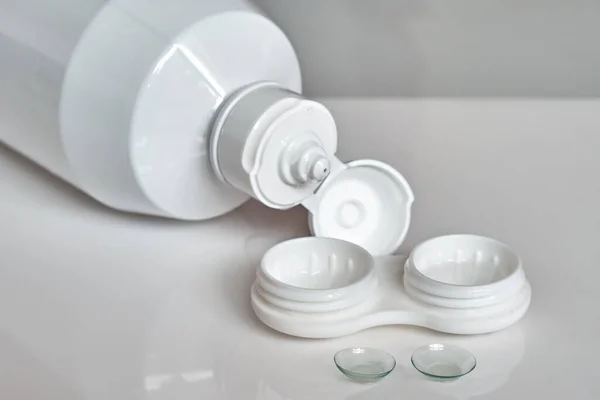 Stock image Contact lenses, a bottle of cleaning liquid and a container for them. The topic of medicine and health care.