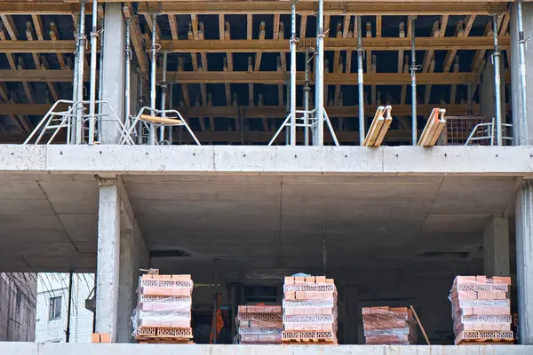 stock image Bricks in pallets on a construction site. Construction of an apartment building.