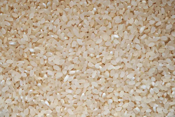 Rice groats. Background from rice cereal. View from above