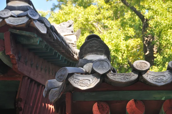 Traditional ceiling tiles of Korean Hanok Village building with old wooden roof in the afternoon in Seoul, South Korea