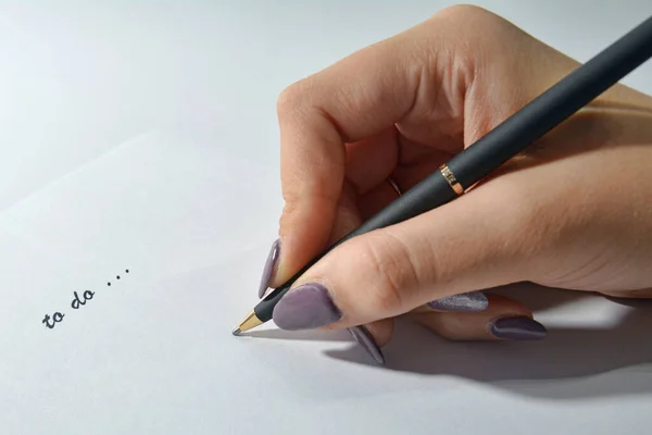 stock image hand writing to do list on paper with pen