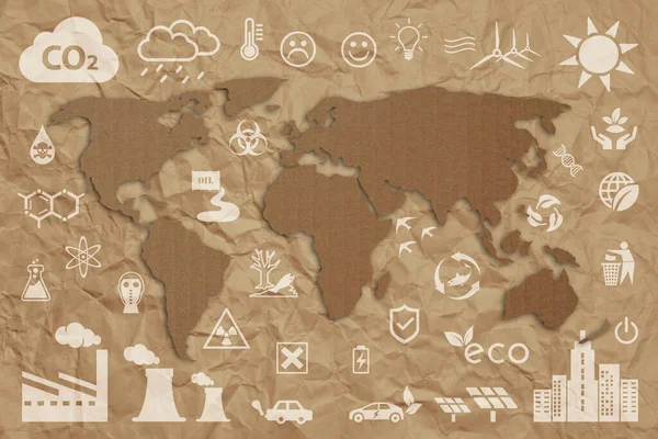 Ecology concept: sustainable World. A green grass textured World map above a cardboard, with several white ecology icons superimposed on background.