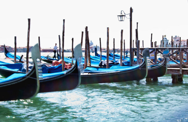 Panning view of characteristic Gondolas moored in Venice