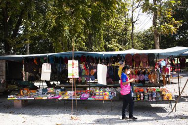 Yerel pazar tezgahı gezginleri Tay gezginleri, 3 Kasım 2022 'de Suphan Buri Tayland' da, Wat Thap Kadar Tapınak Çarşısı 'ndaki bahçe parkında alışveriş yiyecek içecek ürünlerini ziyaret eder.