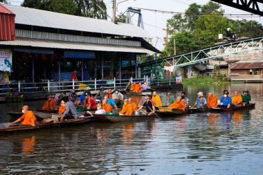 Taylandlı gezginler, 8 Kasım 2022 'de Nonthaburi Tayland' da Wat Sai Yai kanalında Keşiş alayı için yapılan törenlere katılıp dua ediyorlar.