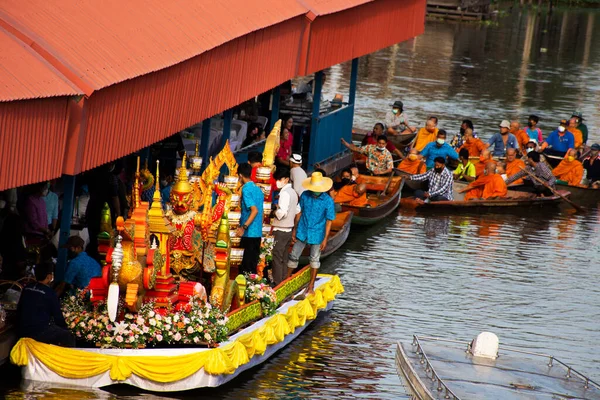 stock image Thai people foreign traveler travel visit and join tradition merit ritual and praying offering alms giving to monk procession on boat in canal at Wat Sai Yai on November 8, 2022 in Nonthaburi Thailand