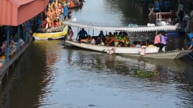 Taylandlı gezginler, 8 Kasım 2022 'de Nonthaburi Tayland' da Wat Sai Yai kanalında Keşiş alayı için yapılan törenlere katılıp dua ediyorlar.