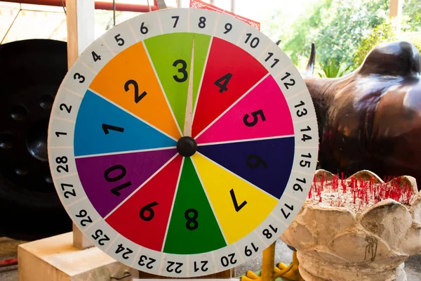 Lucky numbers wheel of fortune game for thai people travelers travel visit and playing gambler risk taking and seamsi fortune telling at outdoor of Nakhonprathom city in Nakhon Pathom Thailand
