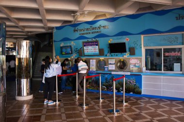 Thai people foreign travelers travel visit wait and stand in queue for buy tickets from ticket booth box of Institute Marine Aquarium and Science at Bangsaen on December 28, 2022 in Chonburi, Thailand