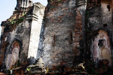 Ancient antique broken buddha statue and ruin damage old chedi stupa for thai people travel visit respect praying blessing holy mystery in Wat Choeng Tha pagoda or Koy Tha temple in Ayutthaya Thailand