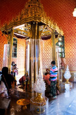 Traveler thai people respect praying and cover thin gold leaf on cover thin gold leaf on buddha statue for blessing wish mystery at Wat Phra Phutthabat temple on January 12, 2023 in Saraburi, Thailand