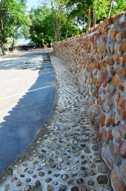 Building wall structure and architecture concrete rock stone with cobblestone at parking in Kaeng Krachan Dam reservoir at Kaengkrachan National Park in Phetchaburi, Thailand