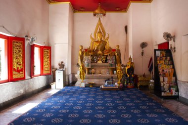 Ancient buddha statue in antique ubosot ordination hall for thai people travel visit respect praying blessing wish mystery holy worship in Wat Palelai temple on January 29, 2023 in Nonthaburi Thailand