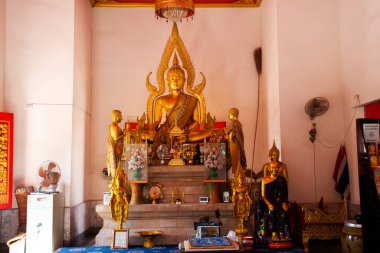 Ancient buddha statue in antique ubosot ordination hall for thai people travel visit respect praying blessing wish mystery holy worship in Wat Palelai temple on January 29, 2023 in Nonthaburi Thailand