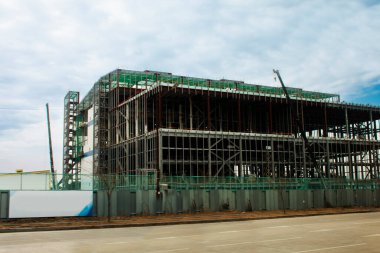 Asian labor people and korean labour workers use machine and heavy machinery working builder new structure tower building on scaffold at construction site in Pohang or North Gyeongsang, South Korea