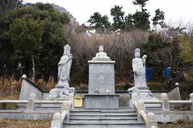 Antik Buda ve Kore tanrıçası Mazu heykeli. Gezginler için dua ederek seyahat ediyorlar. 18 Şubat 2023 'te Güney Kore Jeju Adası' ndaki Sanbangsa Tapınağı 'nda kutsanmış dilek gizemi.