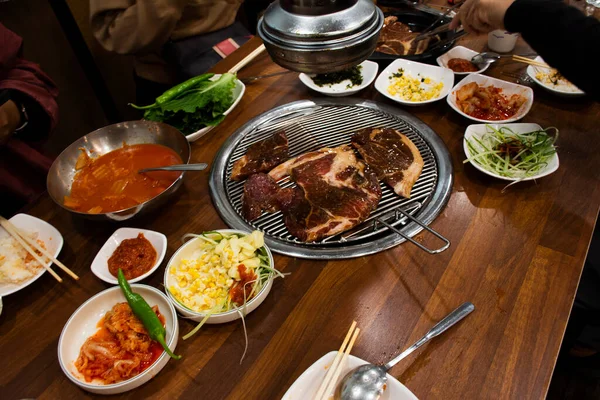 在韩国 当地传统的韩国风味食品济州岛的黑猪烧烤烤肉和韩国人的调味配菜吃当地餐馆的酒菜 — 图库照片