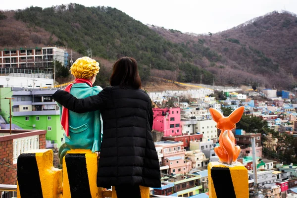 Korean people travelers travel visit take photo with little prince figure and fox statue landmark and landscape cityscape of Gamcheon Culture Village or Santorini of Pusan city in Busan, South Korea