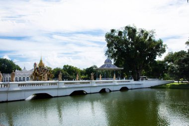 Bahçe parkındaki köprü üzerindeki sanat heykeli ve antik klasik bina Bang Pa 'nın antik retro mimarisi Tayland' ın başkenti Ayutthaya 'daki Bang Pa' ya seyahat eden insanlar için Royal Palace 'da