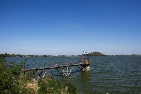 View landscape with old water level measurement station and broken damage wooden bridge in lake dam of Phu Sub Lek catchment with freshness environment on crest reservoir in Lopburi, Thailand