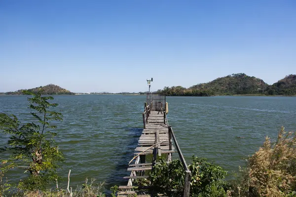 View landscape with old water level measurement station and broken damage wooden bridge in lake dam of Phu Sub Lek catchment with freshness environment on crest reservoir in Lopburi, Thailand