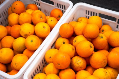 Hayat tarzı geleneksel işportacılık tezgahı Çin 'in Hubei kentindeki Zigui şehrinden seçilen gezginler için sokak pazarındaki plastik sepet kutusunda meyve portakalı satışı.