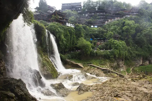 stock image Cityscape historic buildings or heritage antique architectural of Furong Zhen Tujia ancient town city and landscape Wangcun Pubu waterfall for chinese traveler travel visit at Yongshun in Hunan, China