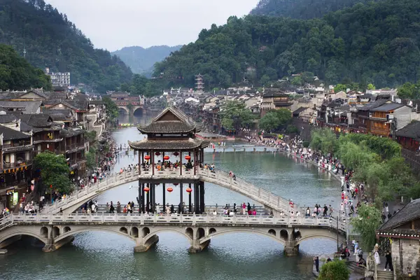 stock image Landscape toujiang river and cityscape historic building with heritage architecture Reclining rainbow bridge of Xiangxi phoenix fenghuang ancient city for traveler visit on May 9, 2024 in Hunan, China