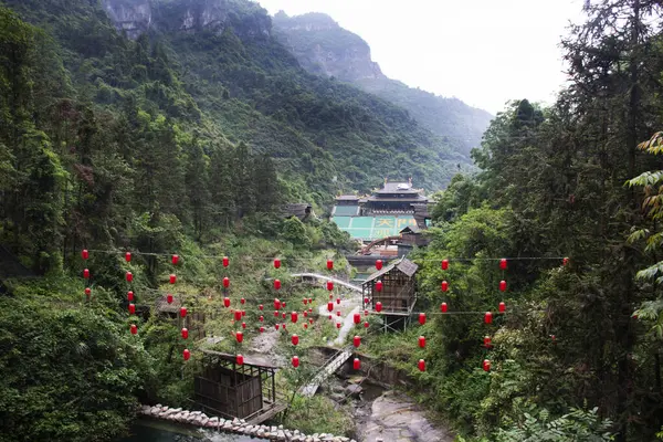 stock image View landscape Tianmen Mountain with antique building architecture of stage theater chinese actor actress acting love story of woodman and fairy fox for show travelers on May 9, 2024 in Hunan, China