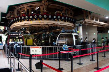 Japanese people foreign travelers at station use Hakone Ropeway and Tozan Cable car for journey travel visit Owakudani mountain eruption and Sulfur vapors at Hakone on July 6, 2024 in Kanagawa, Japan clipart