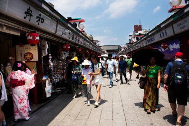 Japanese people travelers travel visit shopping select buy gifts souvenirs on Shin Nakamise dori Shopping Street Local antique Market of Asakusa in Taito City at Tokyo on July 4, 2024 in Kanto, Japan clipart