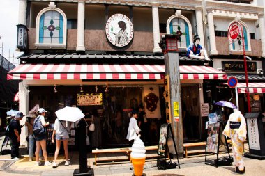 Japanese people travelers travel visit shopping select buy gifts souvenirs on Shin Nakamise dori Shopping Street Local antique Market of Asakusa in Taito City at Tokyo on July 4, 2024 in Kanto, Japan clipart