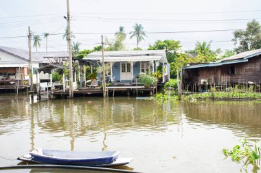 Life lifestyle of local thai people riverside Khlong Om Non canal river with landscape cityscape Bangyai village and classic vintage retro house antique home at Bang Yai city in Nonthaburi, Thailand clipart