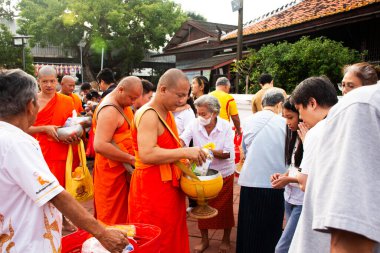 Tayland halkı, 18 Ekim 2023 'te Nonthaburi Tayland' da, Wat Prasat tapınağındaki Budist Perhiz töreninde Tak Bat Devo Budizm Festivali 'ne katılır ve rahiplere yemek sunar.