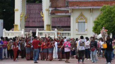 Yerel thai halkı geçit törenine katılıyor. 20 Ekim 2024 'te Nonthaburi, Tayland' da Kathin Prasat tapınağında Budist keşiş veya Budizm rahibine adak sunuyorlar.