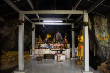 Ancient buddha or antique hermit eremite statue in old shrine for thai people travel visit respect praying at Wat Tham Bo Ya or Thep Nimit Songtham Temple on November 2, 2024 in Nakhon Sawan, Thailand clipart