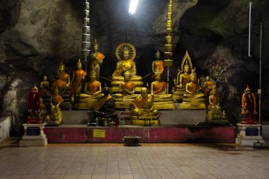 Antique tunnel cave for thai people travel visit respect praying ancient holy buddha and myth deity angel at Wat Tham Bo Ya or Thep Nimit Song Tham Temple on November 2, 2024 in Nakhon Sawan, Thailand clipart