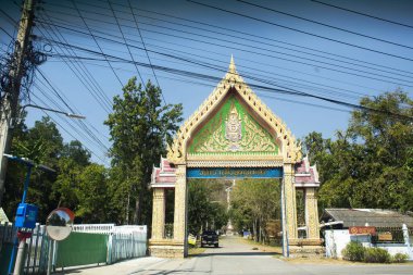 Ancient gate entrance of Wat Khao Meng Amornmet Temple for thai people traveler travel visit and respect praying blessing holy buddha antique deity angel on December 26, 2024 in Kanchanaburi, Thailand clipart