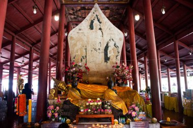 Holy ancient recline buddha statue Luang Pho Phet in antique ubosot for thai people travel visit respect blessing in Wat Sing or Singh temple at Sam Khok on December 30, 2024 in Pathum Thani, Thailand clipart