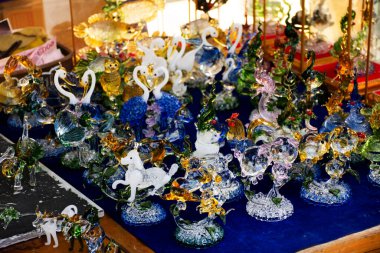 Variety blowing glass crafts souvenir and handicrafts forming molten glass in handmade gift shop studio for thai people traveler select buy in local market bazzar at Sam Khok in Pathum Thani, Thailand clipart