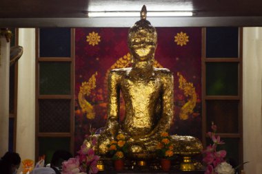 Holy ancient buddha statue Luang Phor Luea for thai people travelers travel visit respect praying blessing wish antique angel deity myth worship in Wat Bot temple at Sam Khok in Pathum Thani, Thailand clipart