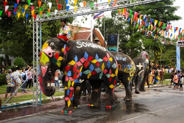 Songkran Festivali 'ne katılmak üzere canlı boyanmış filler ve Tayland mahout bekçileri 13 Nisan 2025' te Ayutthaya, Tayland 'a seyahat eden ziyaretçilere su püskürtmek için hortumlar kullanacaklar.