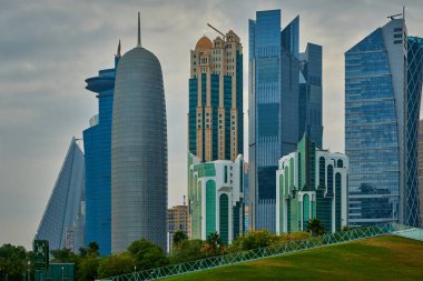 Doha skyline, Doha Qatar  from the hotel park afternoon shot showing West Bay skyscrapers .