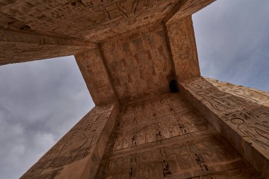 Mortuary Temple of Ramesses III at Medinet Habu in Luxor, Egypt showing Ceiling decoration in the peristyle hall with preserved colors