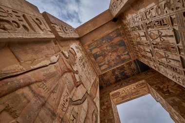 Mortuary Temple of Ramesses III at Medinet Habu in Luxor, Egypt showing Ceiling decoration in the peristyle hall with preserved colors